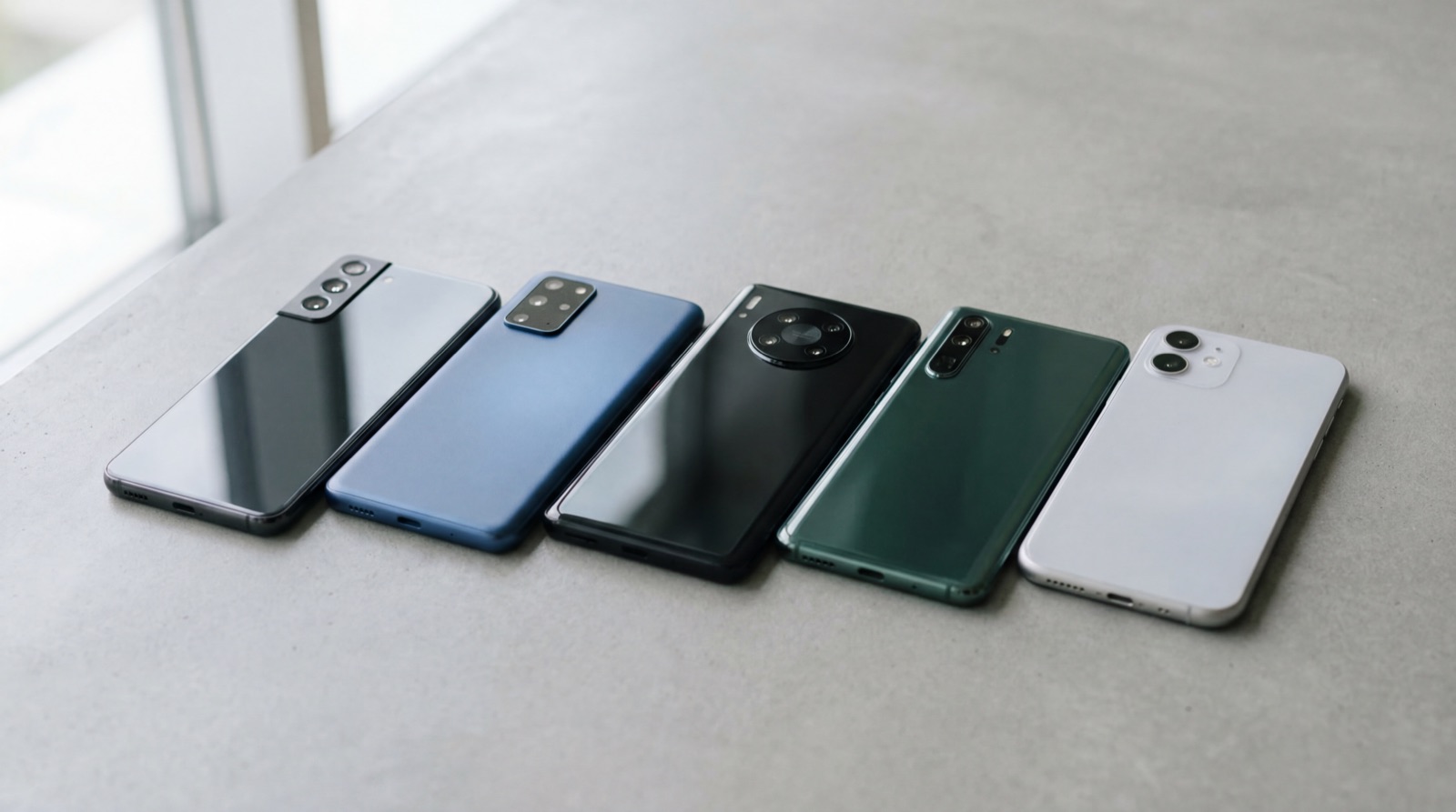 Several mid-range smartphones on a neutral background.